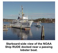 Starboard-side view of the NOAA ship RUDE docked near a passing lobster boat.