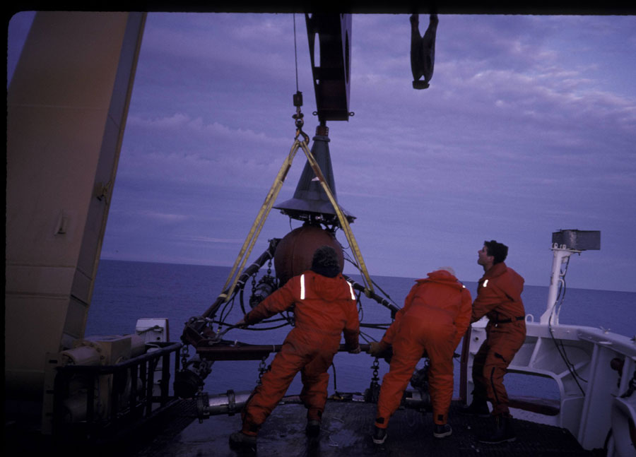 Photograph of the seismic system on deck, showing the air guns and frame, the towing weight, and the conical steel trumpet that protected the wet end connection point - Full Size