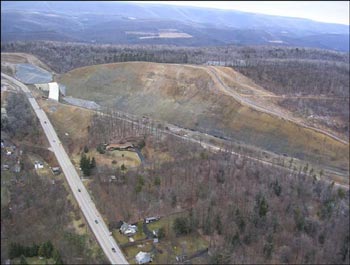 Aerial view of the Skytop cut on January 6, 2005 looking north. Existing Route 322 in foreground. Future I99 roadbed runs along the base of the cut. Black plastic covers one of several areas of pyritic fill as a stopgap measure to minimize water infiltration.