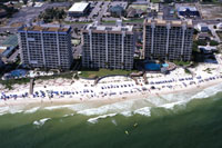 Photo showing beach and three high-rise buildings.