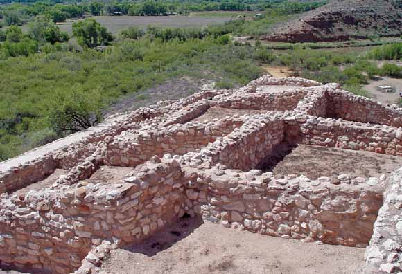 photo of ruins consisting of low stone walls that delineate rooms in dwellings