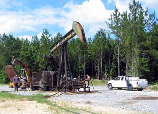 Color photograph of CZ Fee A No. 114 well pumpjack .