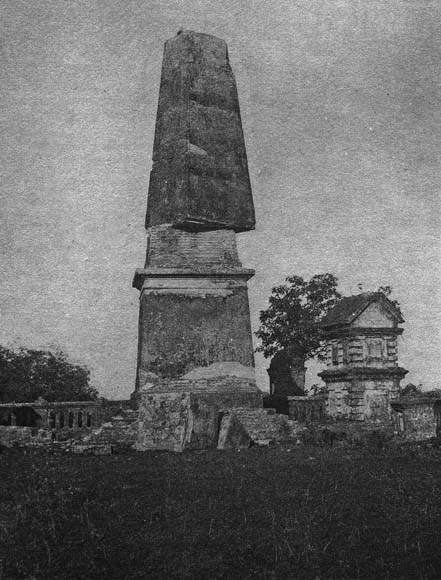 photo of stone tower with top twisted on vertical axis