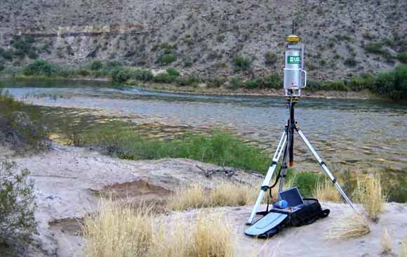 Photograph of survey equipment on a sandbar with the river in the background