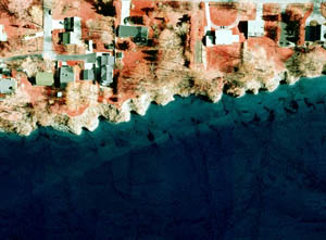 Figure 8. Aerial photograph showing headland-cove morphology formed in portions of the Lake Erie, Pa., bluffs in areas where jointed bedrock makes up the bluff face. The morphology can also be seen in the submerged portion of the bluff, where the jointing in the bedrock is also visible. Photograph from Pennsylvania Coastal Resource Management Program.
