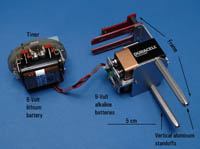 Figure 8. Photograph showing the configuration of the timer and the 9-volt battery pack held within a frame designed by USGS technicians. The frame is constructed of fiberglass and aluminum and is secured to the bottom of the pressure case by the two vertical aluminum standoffs.