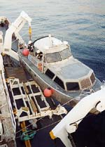 Thumbnail image of figure 5, and link to larger figure. Photograph of launch boat being deployed from the research vessel.