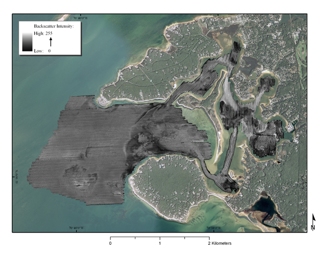 Figure 8:  Map showing backscatter intensity recorded with a Systems Engineering Assessment (SEA, 2010) SWATHplus interferometric sonar system during the USGS geophysical survey of Red Brook Harbor, MA. Low backscatter values are represented by dark tones, while high backscatter returns are shown by lighter tones.