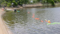 Thumbnail image for Figure 2, photograph of CRP streamer deployed behind the survey boat, and link to larger image.