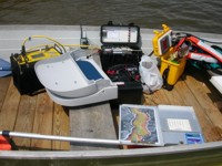 Thumbnail image for figure 5, photograph of CRP acquisition equipment in the boat, and link to larger image.