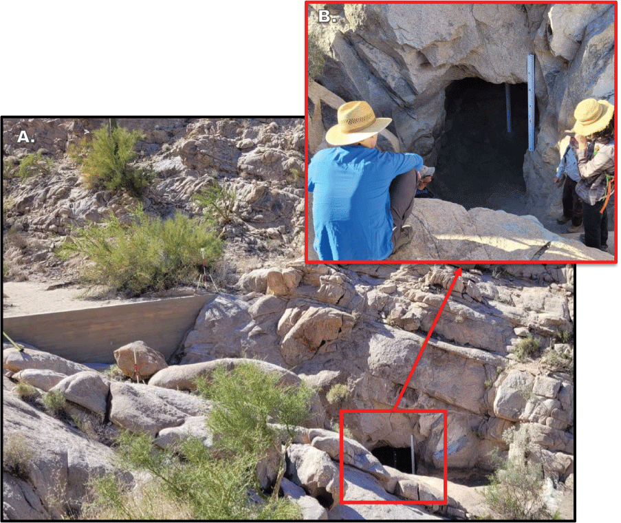 1. The tank looks like a dark cave in rock cliff below dam, and two people sit looking
                     at the tank.