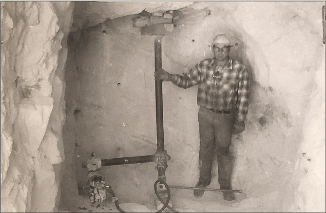 2.26. A person within an excavated void holds on to a pipe connected to other equipment.