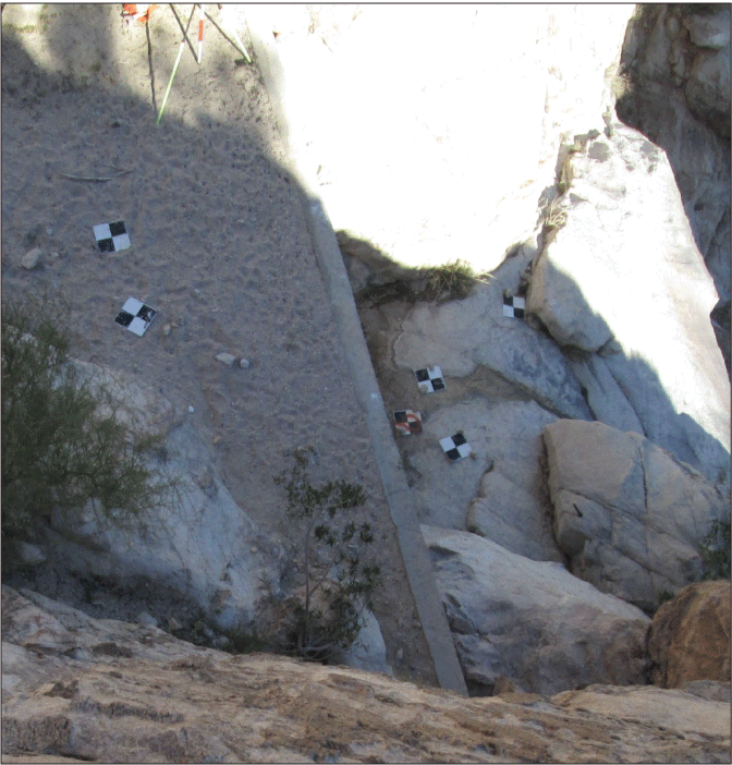 2.31. Sediment reaches the top of a concrete wall on the upstream side. Downstream
                  of channel bed is lower and not visible.