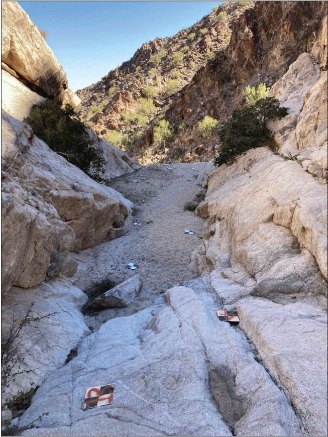 2.32. Narrow channel bounded by rock with medium-to-fine textured sediment within
                  channel bed. Channel end abruptly at downstream drop.