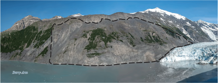 The landslide area is steep and minimally vegetated. A ridge and snow-capped peaks
                     are above the landslide area, and ocean water is below.