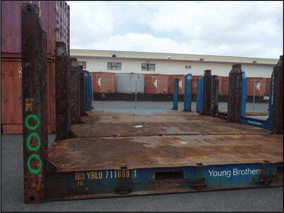 19. Empty flat racks lined up on a paved surface.