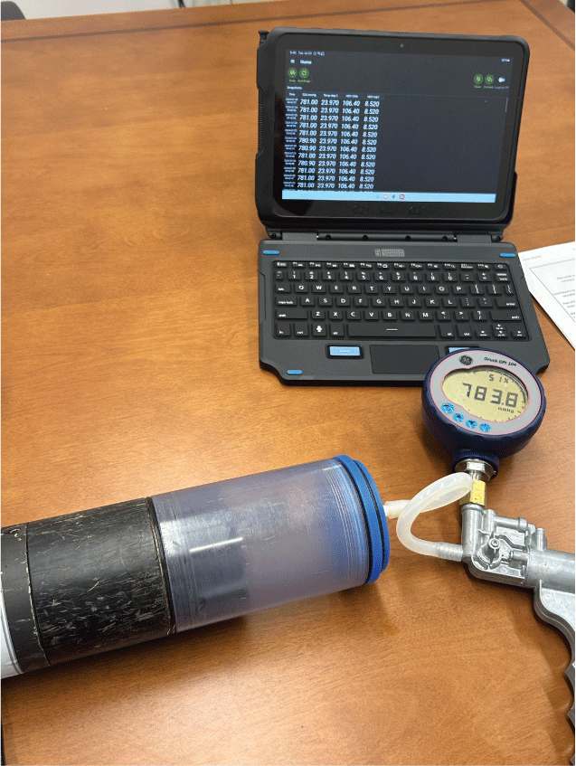 Pressure gauge attached to a modified calibration cup used to compare total dissolved
gas readings with pressure for accuracy check.