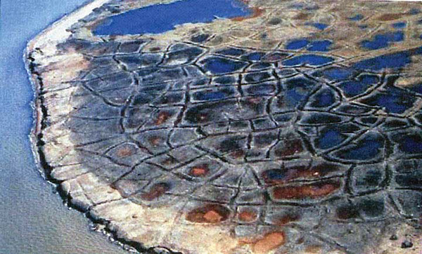 Figure 6-3.–Oblique aerial photograph of ice-wedge polygonal ground on the Alaska Arctic coastal plain. Photograph by Robert I. Lewellen, Lewellen Arctic Research, Inc., Palmer, Alaska.