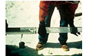 Figure 8-4. Glaciologist extracting glacier ice core from a drilling barrel on the 6,100 meters col (pass) of Huascarán, Perú, in July 1993. Photograph by Lonnie G. Thompson, Byrd Polar Research Center, The Ohio State University, Columbus, Ohio. 