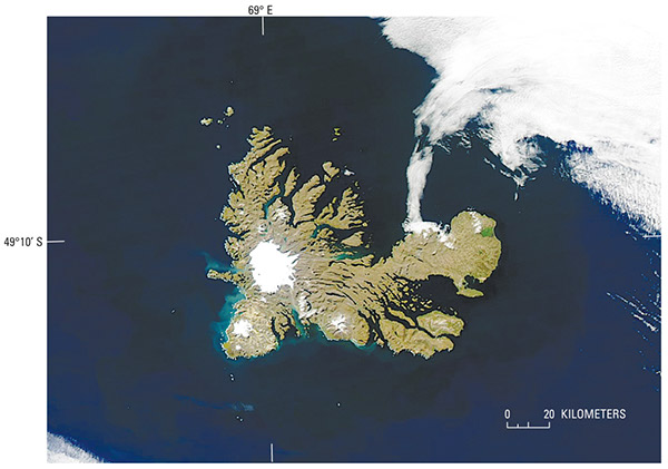 Figure 15.—MODerate-resolution Imaging Spectroradiometer (MODIS) image of Île Kerguelen (Îles Kerguelen) on 4 March 2004. Cook Glacier (ice cap) and its outlet glaciers (12 named) are visible, as are glaciers (5 named) on three peninsulas: Presqu’ île de la Société de Géographie (north of Cook Glacier), Presqu’ île Rallier du Baty (southwest of Cook Glacier), and Presqu’ île Gallieni (southeast of Cook Glacier). NASA Aqua MODIS image. [http://visibleearth.nasa.gov; KerguelenIslands; File-Kerguelen. A2004064.0945.250m.jpg]