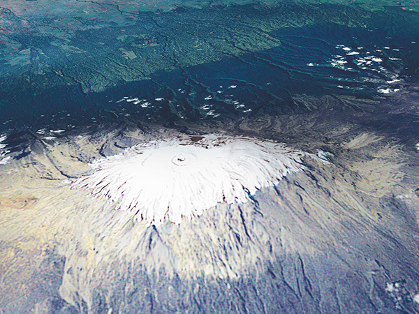 Figure 14.—Glacier ice and snow on Mount Kilimanjaro, Tanzania, Africa, a 5,895-m
high volcano. The image was acquired on 17 February 1993, by the Thematic Mapper
on the Landsat-5 satellite and was draped over a digital elevation model to give an
enhanced sense of the three-dimensional shape of the mountain. Image courtesy of
NASA’s MODIS Land Rapid Response Team. 

