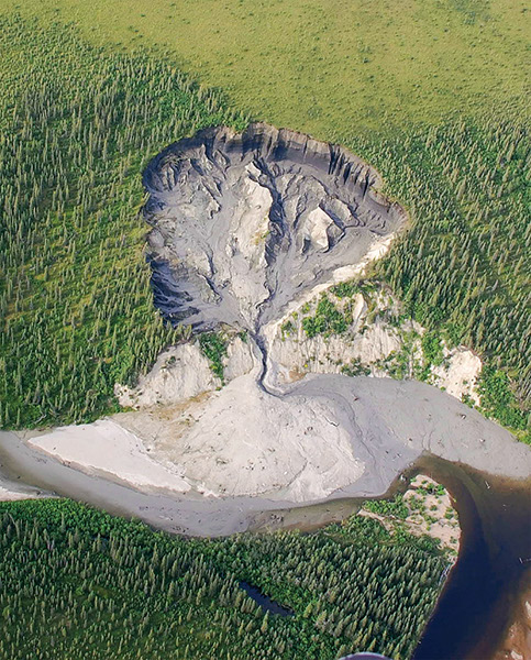 Figure 27.—Large retrogressive thaw slump, northwest Alaska, triggered by lateral erosion of the Selawik River (photograph by Kenji Yoshikawa, University of Alaska Fairbanks). 
  