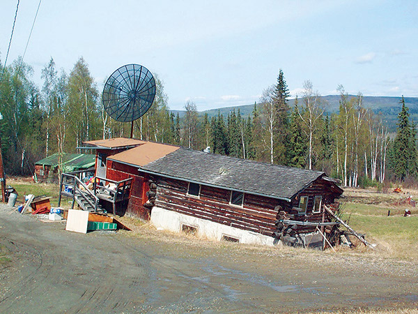 Figure 42.—Failed building as a result of differential thaw of ice-rich permafrost,
Fairbanks, Alaska (photograph taken May 2004 by Vladimir Romanovsky,
University of Alaska, Fairbanks). 
  
