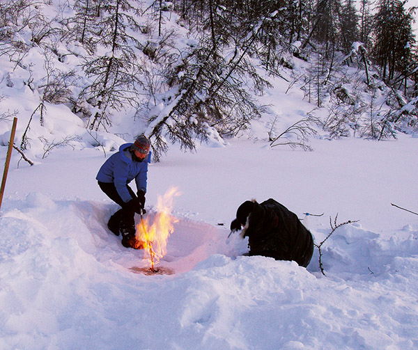Figure 50.—Combustion of methane from organic-rich sediments at Shuchi Lake,
Siberia, Russia, in March 2007. Katey W. Anthony is on the left, Nikita Zimov on the
right. Photograph by Sergey A. Zimov, Director, Northeast Science Station, Cherskii,
Republic of Sakha (Yakutia), Russia. (Photograph courtesy of Katey W. Anthony,
University of Alaska Fairbanks, Alaska.) 
  