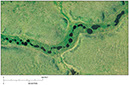 Figure 23.—Vertical aerial photograph of beaded stream channels resulting from melting of ice wedges and thawing of surrounding ice-rich permafrost.
The photograph was taken in summer 2004 south of the town of Nuiqsut, northern Alaska, by M.T. Jorgenson, ABR, Inc., Fairbanks, Alaska. 