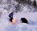 Figure 50.—Combustion of methane from organic-rich sediments at Shuchi Lake,
Siberia, Russia, in March 2007. Katey W. Anthony is on the left, Nikita Zimov on the
right. Photograph by Sergey A. Zimov, Director, Northeast Science Station, Cherskii,
Republic of Sakha (Yakutia), Russia. (Photograph courtesy of Katey W. Anthony,
University of Alaska Fairbanks, Alaska.)  