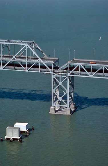 low-angle photo of collapsed section of the Oakland Bay Bridge.  Photo by John Nakata taken from a plane piloted by Bill Updegrove