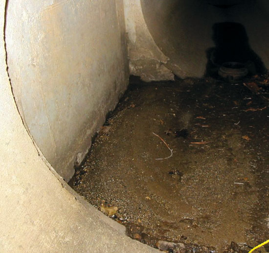 Figure 20. Accumulation of sediment in the junction of a manhole with the storm-sewer conveyance system.