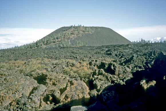Photo of young volcano and barely weathered lava in foreground