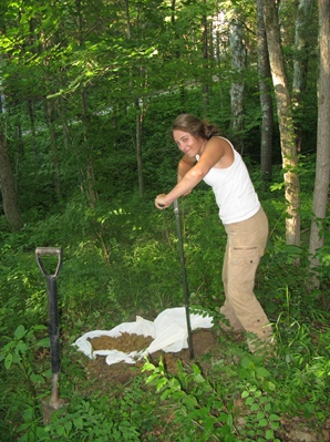 Photograph of Helen Whitney digging in woods