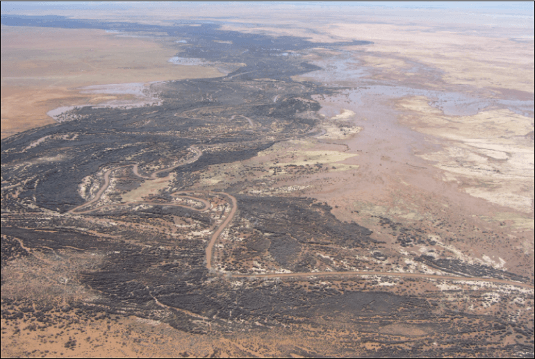 Figure 21.	Aerial photograph looking northwest from south end of study area. Large
                           areas of ponded water are visible from a flood on the Little Colorado River that peaked
                           one month before the photograph was taken.