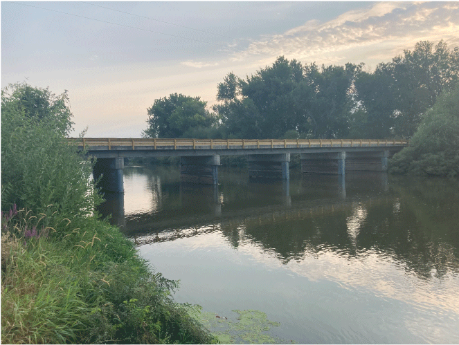 Photograph showing the upstream side of Idaho Department of Transportation bridge
                           structure 27415, July 28, 2021. The photograph shows the sonar device at bent two.
                           The site is co-located with U.S. Geological Survey (USGS) station Boise River near
                           Parma, Idaho (USGS station number 13213000).