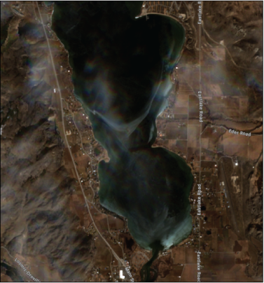 Osoyoos Lake and surrounding land features are shown. Very light cloud cover is visible.