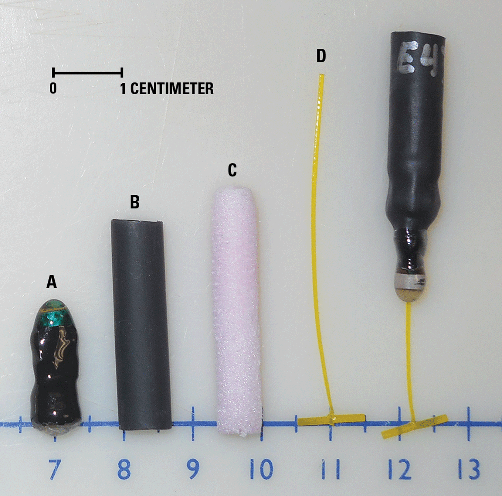 Photograph showing materials used to construct the external acoustic transmitter attachment
                        device and the assembled device.