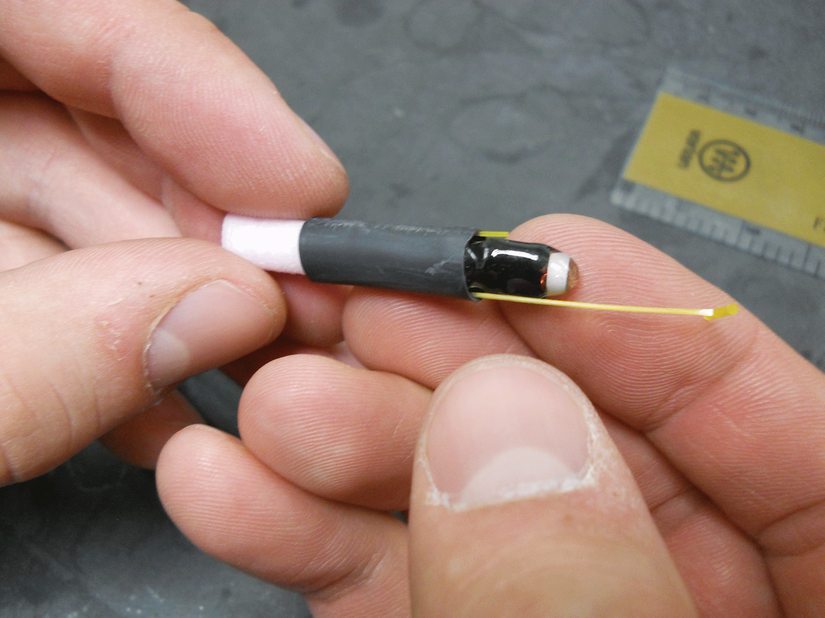 Photograph showing transmitter pushed into shrink tubing.