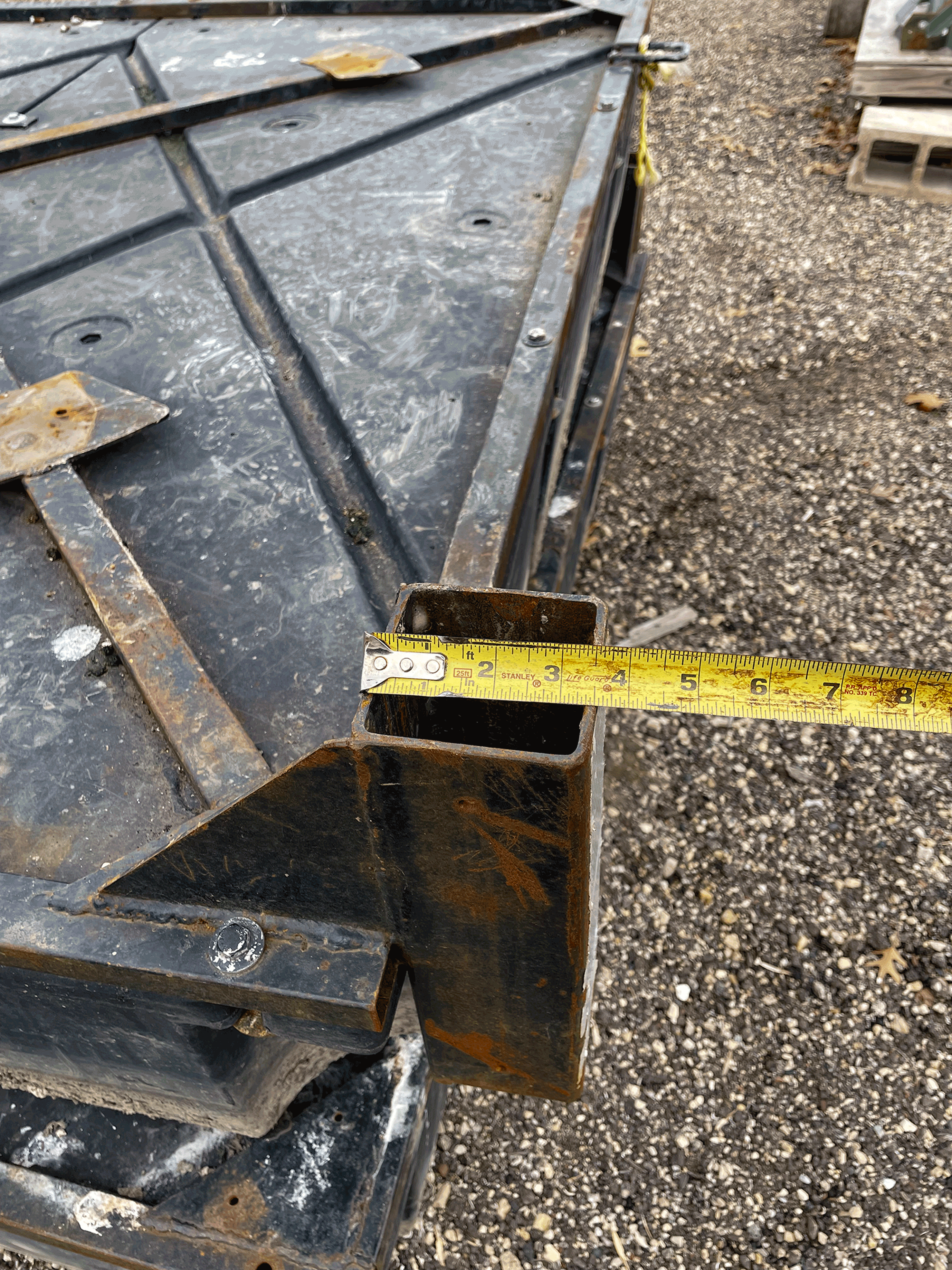 A tape measure placed over the metal support bracket indicates the widest part of
                        the bracket is about 3.5 inches.