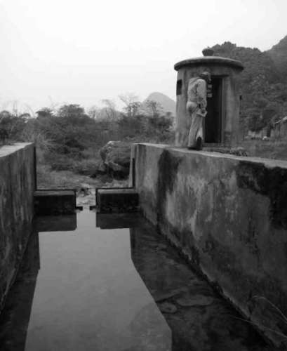 Figure 2. Spring 31 near Guilin, China, showing flume and rectangular weir, prior to equipment installation. Photo by C. Groves.